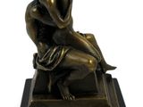 bronze statue of a woman sitting on a stool
