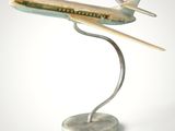 statue of an airplane on a marble base on a white background