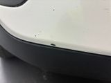a close up of a car ' s bumper with a hole in it