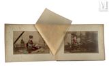 an old photo of a couple of people sitting on top of a table