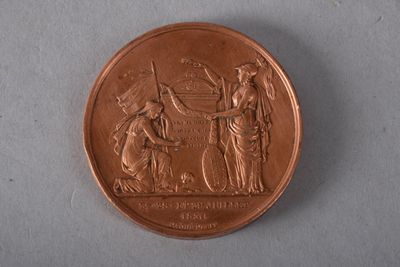 gros plan d'une pièce de monnaie sur laquelle figurent une femme et un homme