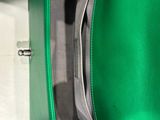 a person holding a green purse in their hand