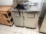 a kitchen with a stainless steel counter top and cabinets