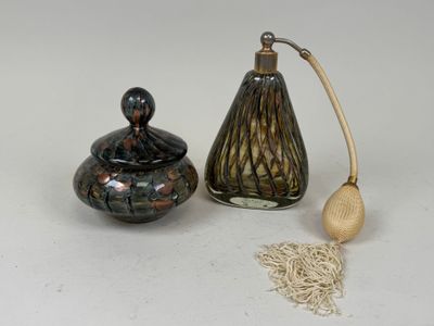 a small glass jar and a wooden spoon next to each other