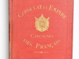 an old red book with gold lettering on it sitting on a white surface