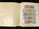 an open book with stamps on it sitting on a table