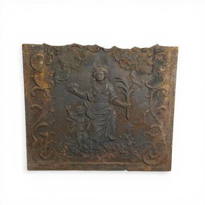 an old metal plaque with a woman and a dog on it