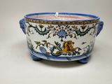 a large blue and white bowl with a lion on it
