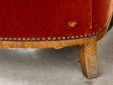 a close up of a red chair with studs on it