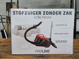 packaging of a red and black vacuum cleaner sitting on top of a wooden table