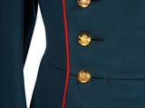 a close up of a military uniform with red pips and buttons