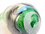 a close up of a glass object on a white surface