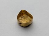 an old gold ring with a small piece of gold in the middle