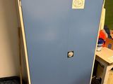 a blue cabinet with a sign on it in the corner of a room