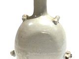 a white vase that is sitting on a table
