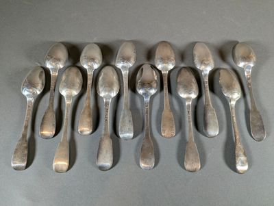 six spoons are arranged in a row on a gray surface