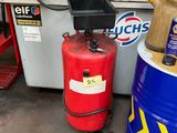two red barrels sitting next to each other in a garage