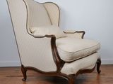 a chair with a foot rest sitting on top of a hard wood floor