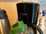 a blender sitting on a counter next to a cup