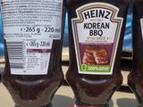 three bottles of ketchup sitting next to each other on a table