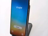 a phone that is sitting on a stand on a table