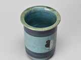 a small blue cup with a black and white cat on it