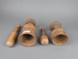 three wooden vases and two wooden spoons on a gray surface