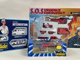 two boxed toys that include a police car, ambulance, and police car
