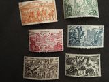a group of stamps with different designs on them on a black surface