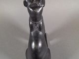 a black statue of a cat sitting on top of a table
