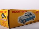 a box of dinky toys sitting on a table