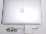 an apple laptop computer sitting on top of a table next to a charger