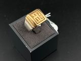 an image of a gold and silver ring in a black box
