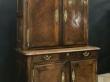 an old wooden cabinet with two doors and a drawer underneath it