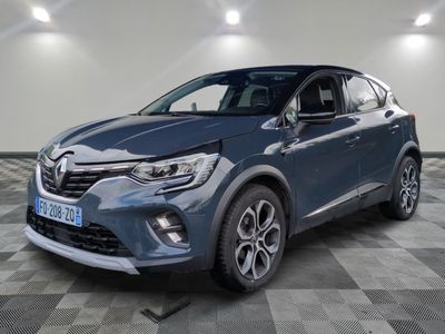 une voiture bleue est garée dans une grande pièce au sol en damier