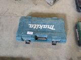 a blue tool case sitting on the floor next to other tools