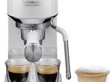 a close up of a coffee maker with two cups of coffee