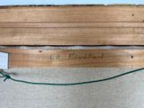 a picture of a piece of wood with a sign on it