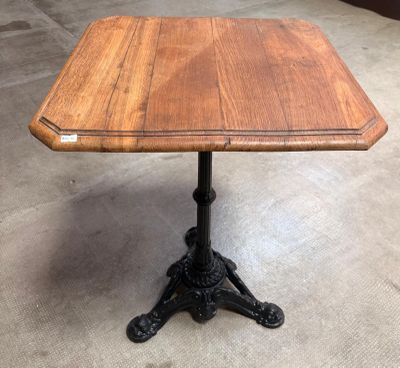 a wooden table with a metal base and a wooden top