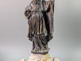 statue of a man with a hat and a robe on a pedestal