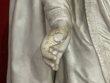 a statue of a man holding a knife and a knife in his hand