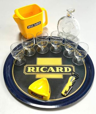 a tray with glasses, a bottle, a knife, and a bottle opener on it
