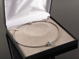 a silver bracelet with a blue stone in a box