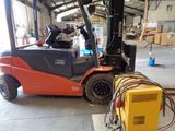 a forklift truck that is parked in a warehouse
