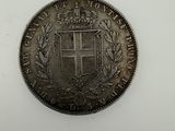 a silver coin with a coat of arms on it