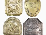 four different types of coins are shown on a white surface
