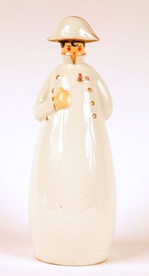 a white figurine of a woman with a hat on