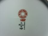 a white plate with a red and black design on it