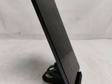 a small black tablet on a stand on a white surface