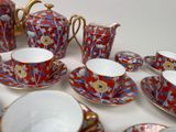 a lot of tea cups and saucers sitting on a table